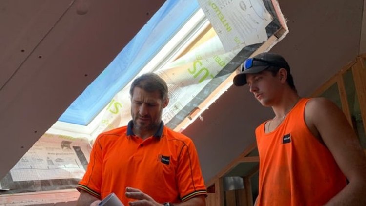 Holah House - Two builders installing INTELLO<sup>®</sup> PLUS on a window