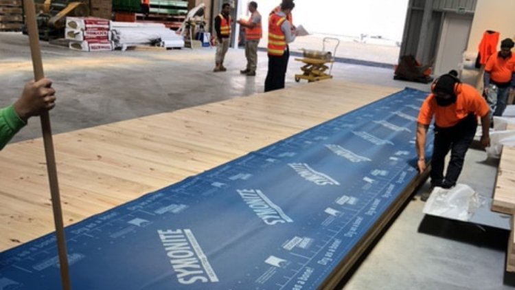 HomeGround Building  - Builders applying SOLITEX EXTASANA <sup>®</sup>  ADHERO to CLT panels