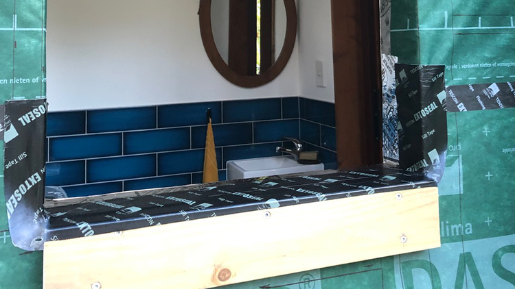 Kaiwaka House - Timber window connected to the weather and airtightness layers using pro clima TESCON EXTORA<sup>®</sup> Weathertight Sealing Tape
