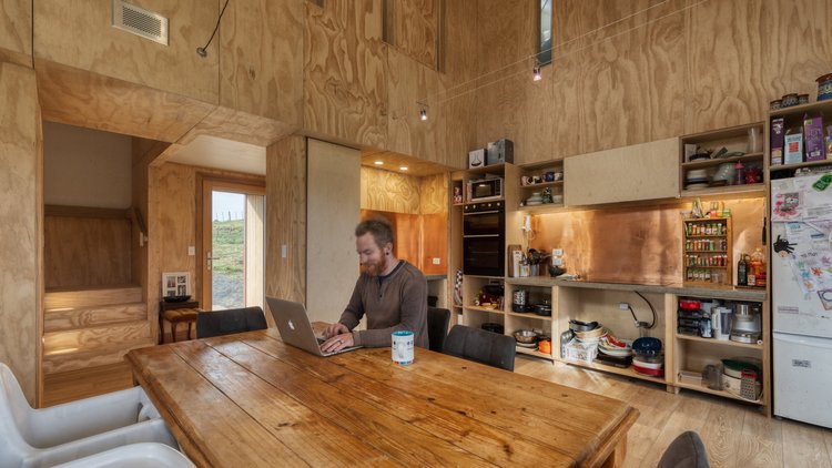 Lyth House - Joseph Lyth  working on a laptop in kitchen