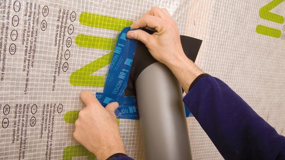 2. Tape the grommet and rub firmly to secure the adhesive bond