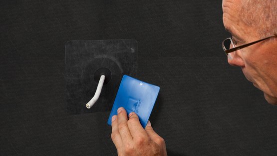 3. Tape the grommet and rub firmly to secure the adhesive bond